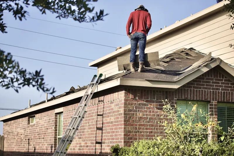 Professional roofer working on a residential roof in Midway